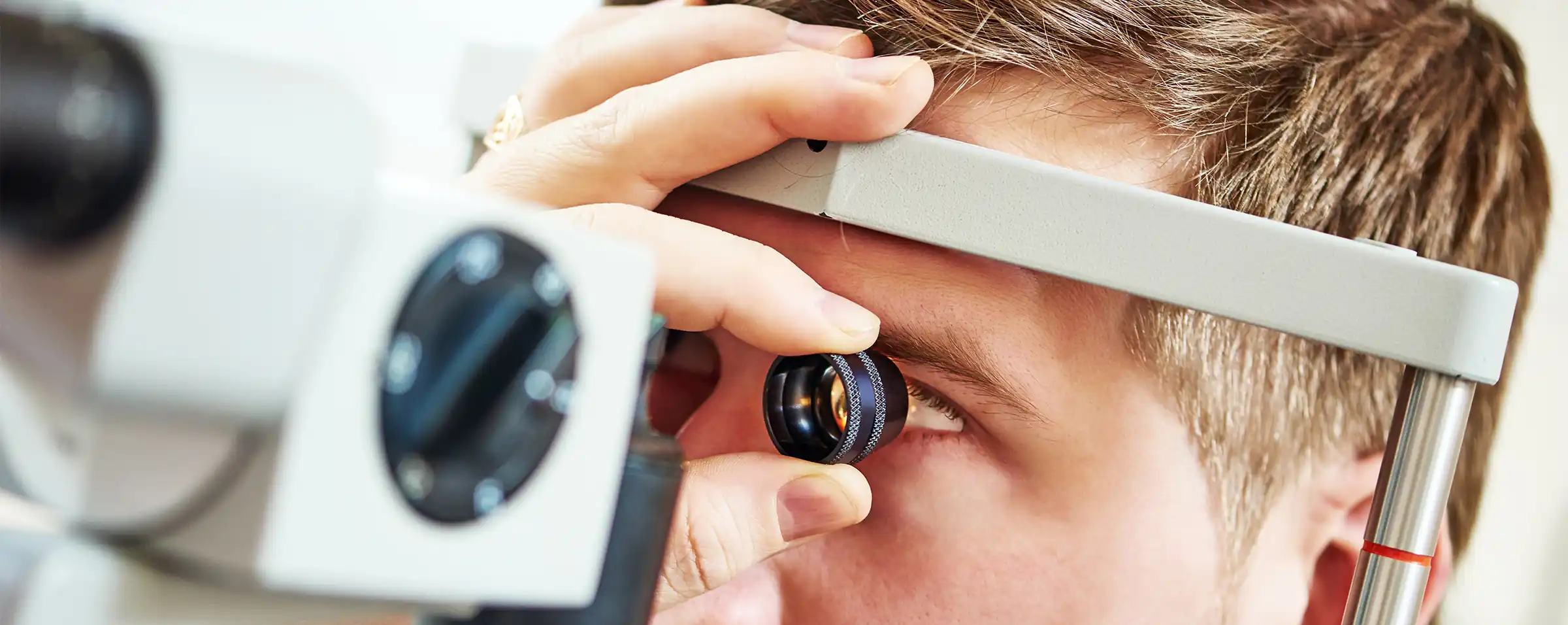 Eye specialist examining patient's cornea